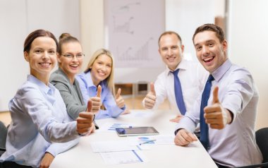 Business team showing thumbs up in office clipart