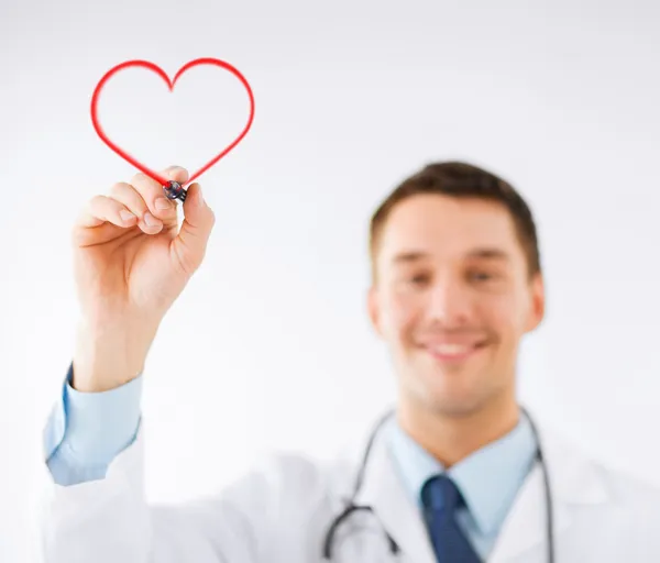 Male doctor drawing heart in the air — Stock Photo, Image