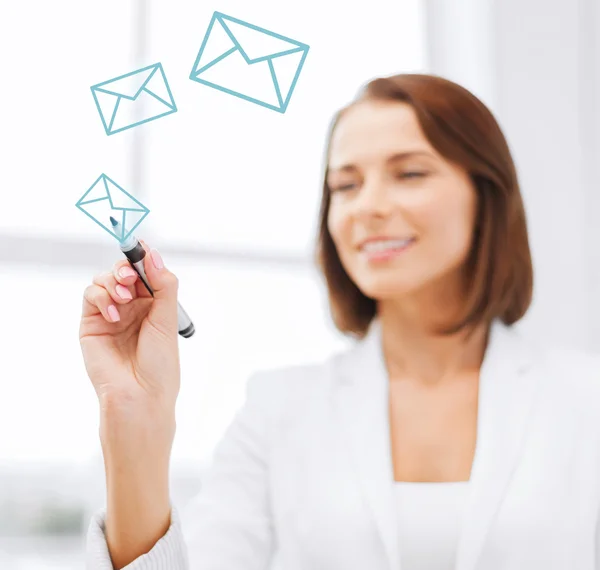 Businesswoman drawing envelopes in the air — Stock Photo, Image