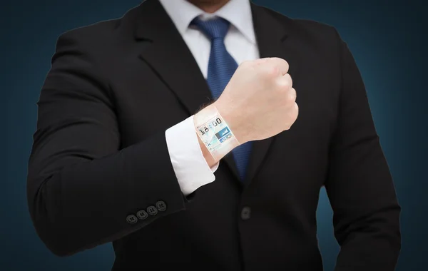 Businessman showing something at his hand — Stock Photo, Image