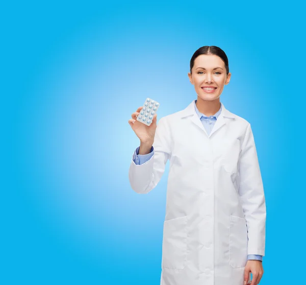 Sorridente medico femminile con pillole — Foto Stock