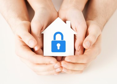 Hands holding paper house with lock clipart