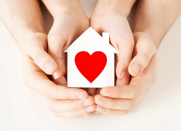 Couple hands holding white paper house — Stock Photo, Image