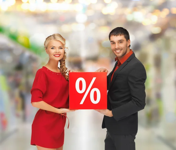 Smiling man and woman with percent sign — Stock Photo, Image