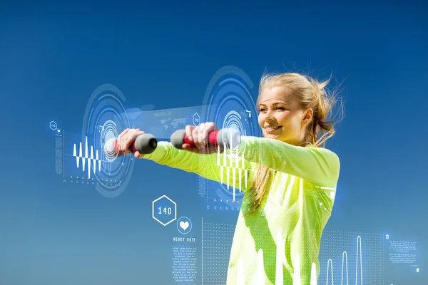 Sporty woman with light dumbbells outdoors — Stock Photo, Image