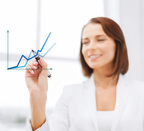 Businesswoman drawing graps in the air — Stock Photo, Image