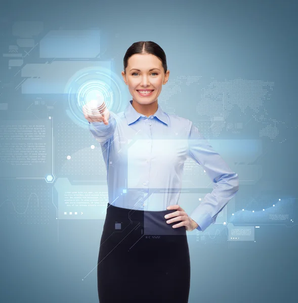 Smiling businesswoman pointing finger to button — Stock Photo, Image