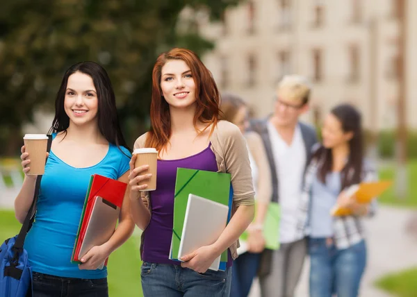 Two students with bag, folders, tablet and coffee Stock Picture