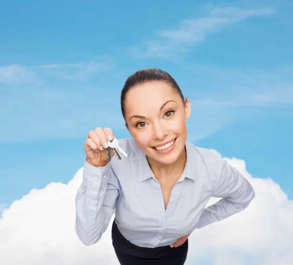 Smiling businesswoman with house keys