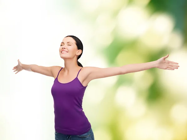 Smiling girl in blank purple tank top waving hands — Stock Photo, Image