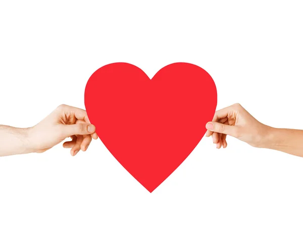 Couple hands holding red heart — Stock Photo, Image