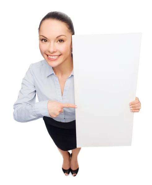 Businesswoman pointing to white blank board — Stock Photo, Image