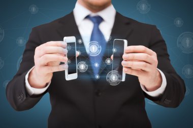 Businessman showing smartphones with blank screens clipart