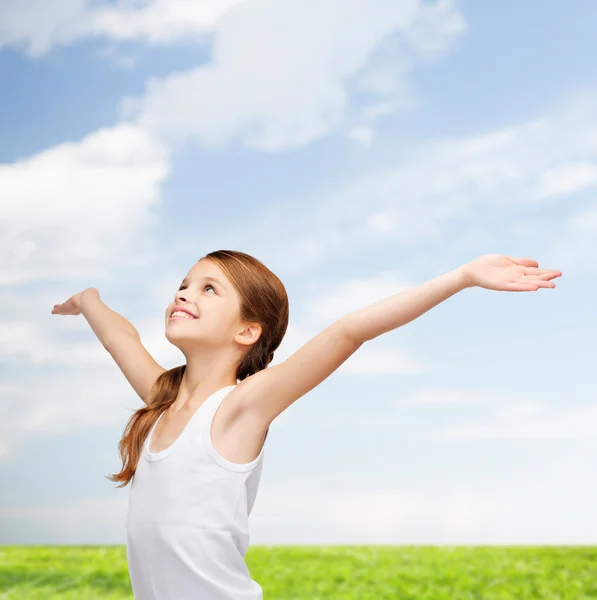 Smiling teenage girl with raised hands — Stock Photo, Image