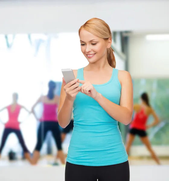 Sportieve vrouw met smartphone — Stockfoto