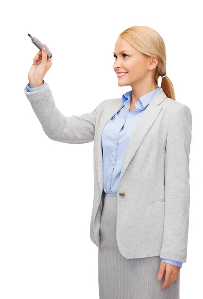 Businesswoman writing something in air with marker — Stock Photo, Image