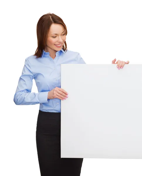 Smiling businesswoman with white blank board — Stock Photo, Image