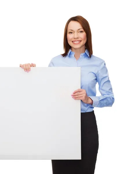 Smiling businesswoman with white blank board — Stock Photo, Image