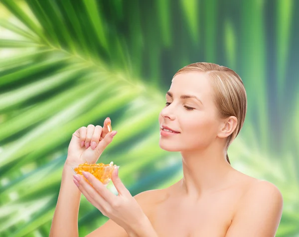 Lovely woman with omega 3 vitamins — Stock Photo, Image