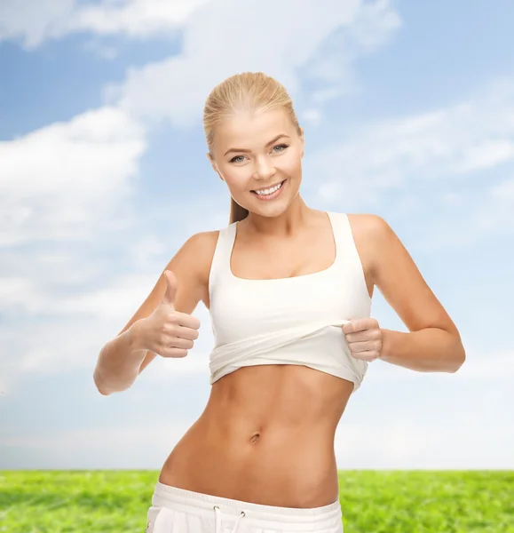 Sporty woman showing thumbs up — Stock Photo, Image