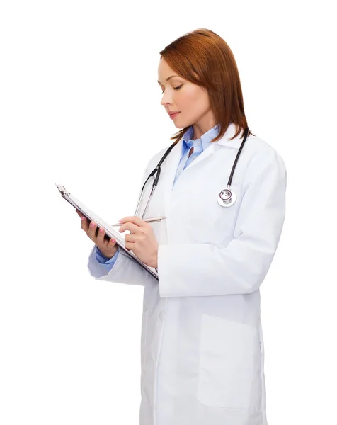 Smiling female doctor with clipboard — Stock Photo, Image