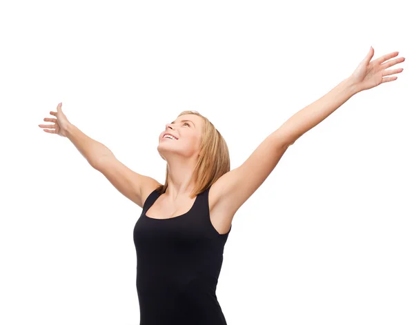 Smiling girl in blank black tank top waving hands — Stock Photo, Image