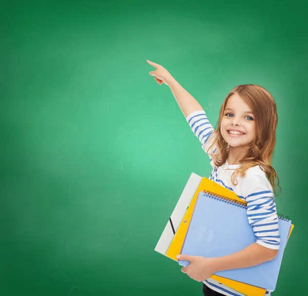 Cute girl with folders pointing at virtual screen — Stock Photo, Image