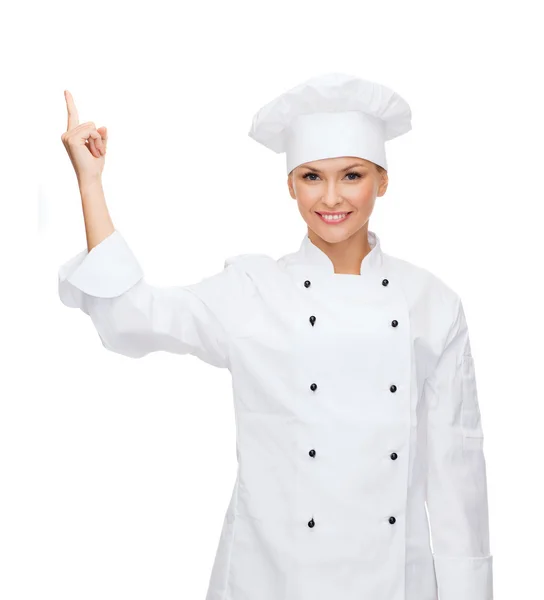 Chef sonriente señalando con el dedo a sonething —  Fotos de Stock