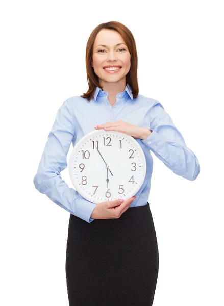 Attractive businesswoman with wall clock — Stock Photo, Image