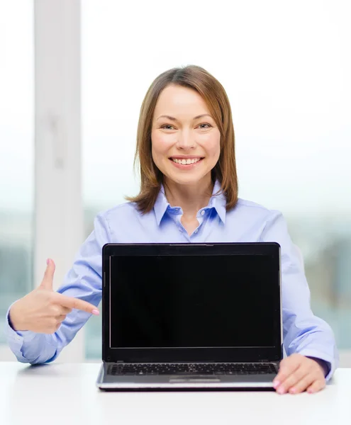 Businesswoman with blank black laptop screen — Stock Photo, Image