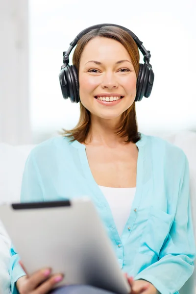 Mujer sonriente con tablet PC y auriculares —  Fotos de Stock