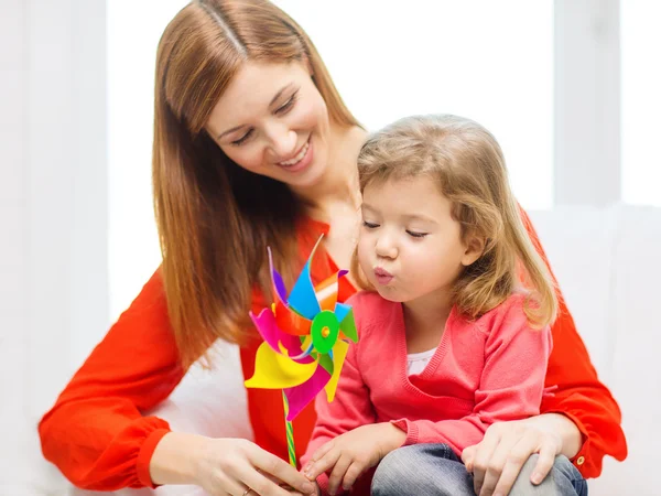 Happy mother and daughter with pinwheel toy — Stock Photo, Image