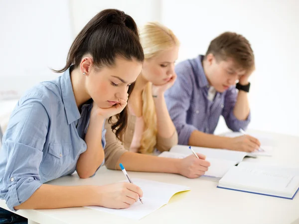 Tired students with notebooks at school Stock Image