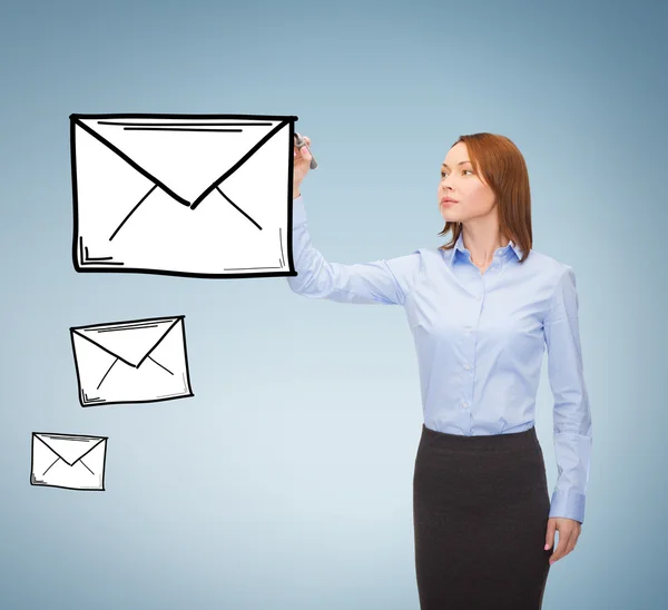 Businesswoman drawing envelope on virtual screen — Stock Photo, Image