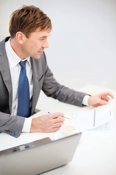 Zakenman met laptopcomputer en documenten — Stockfoto