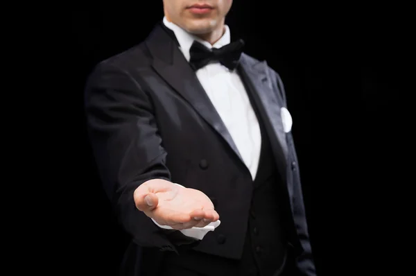 Magician holding something on palm of his hand — Stock Photo, Image