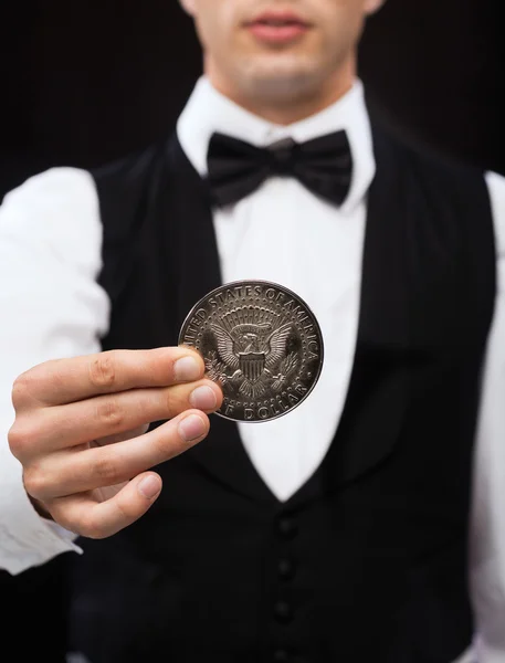 Dealer holding half dollar coin — Stock Photo, Image