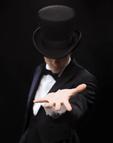 Magician holding something on palm of his hand Stock Image
