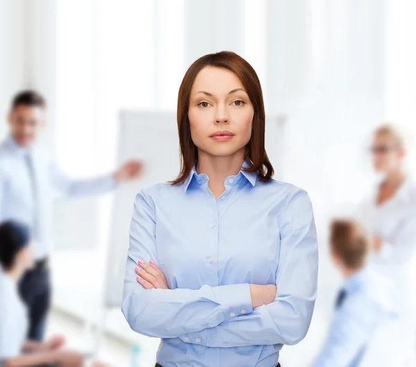 Smiling businesswoman with crossed arms at office — Stock Photo, Image