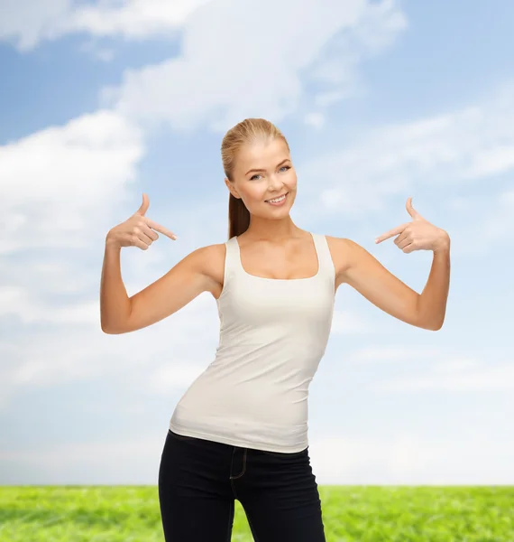 Woman in blank white t-shirt pointing at herself — Stock Photo, Image