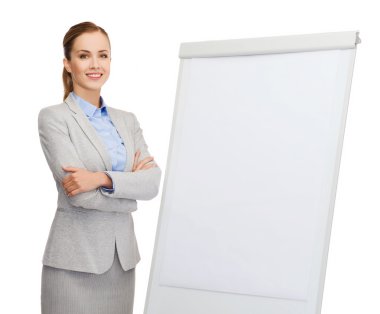 Smiling businesswoman standing next to flipboard clipart