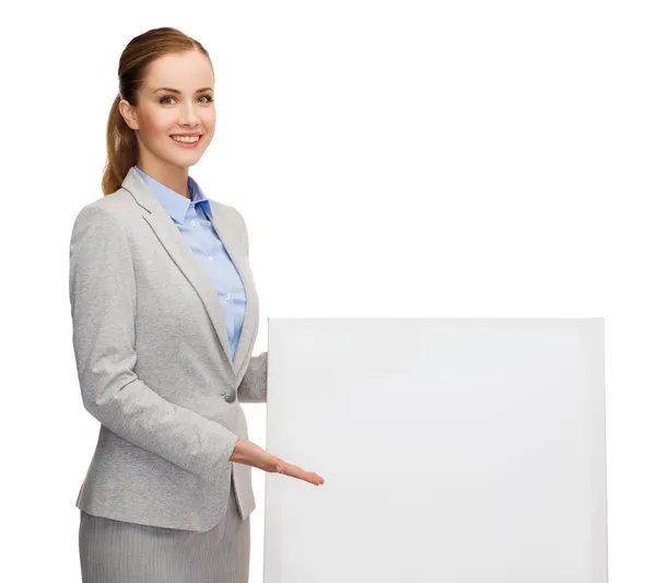 Smiling businesswoman with white blank board — Stock Photo, Image