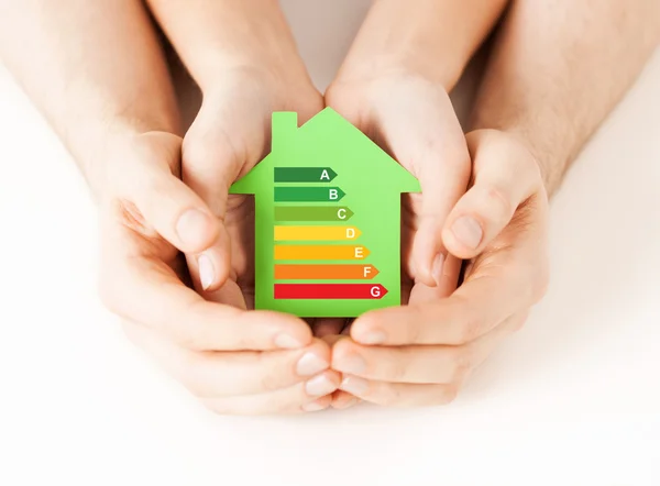 Hands holding green paper house — Stock Photo, Image