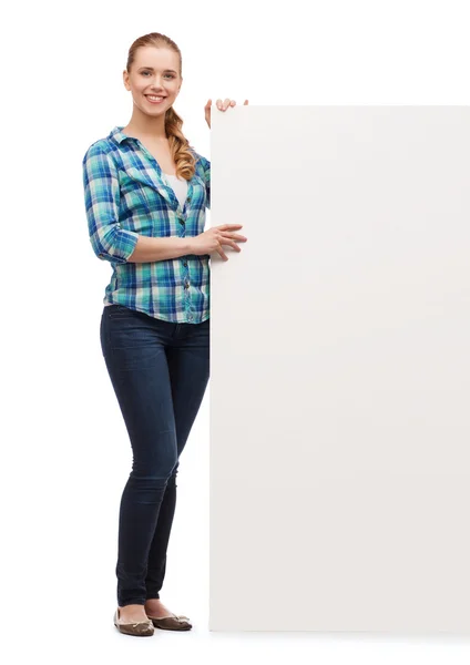 Smiling young woman with white blank board — Stock Photo, Image