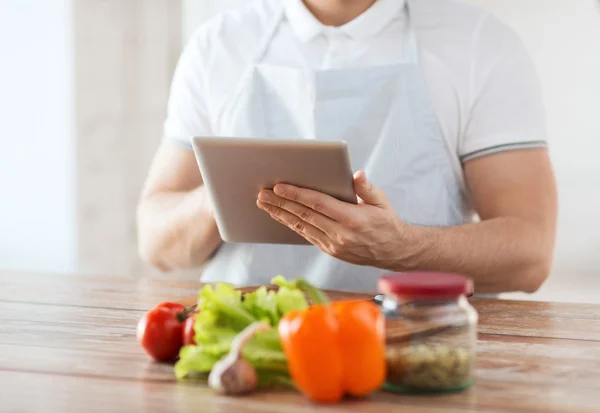 Closeup of man reading recipe from tablet pc — Stock Photo, Image