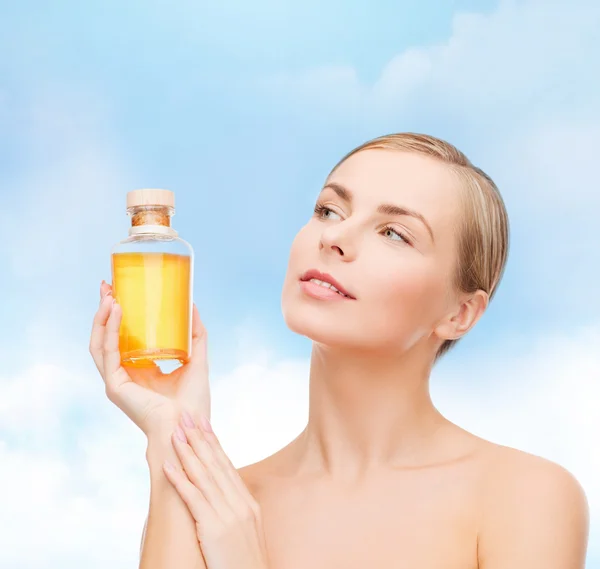 Lovely woman with oil bottle — Stock Photo, Image