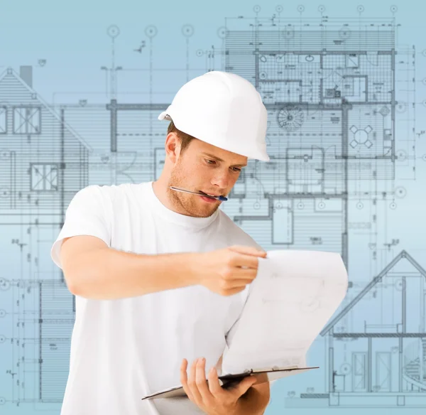Male architect looking at blueprint — Stock Photo, Image
