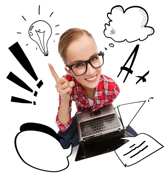 Smiling teenage girl in eyeglasses with laptop — Stock Photo, Image