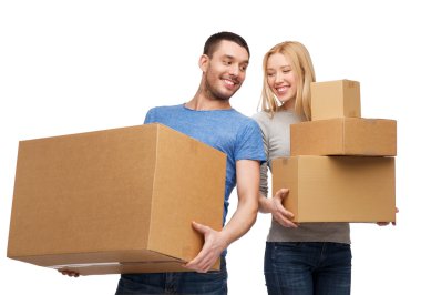 Smiling couple holding cardboard boxes clipart