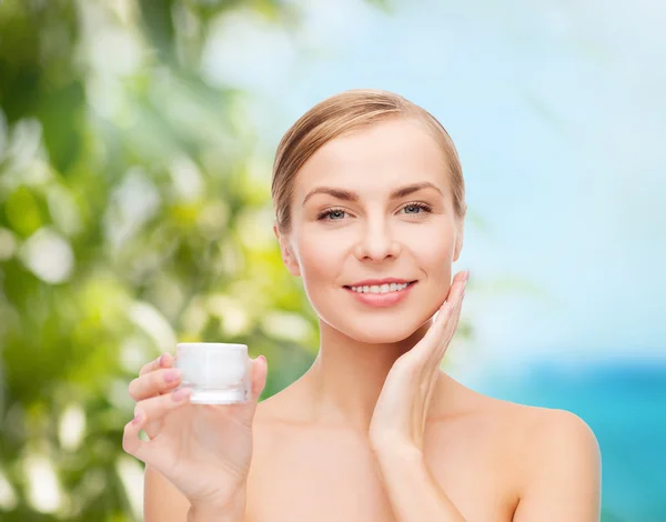 Woman applying cream on her skin — Stock Photo, Image